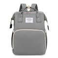 Load image into Gallery viewer, Versatile functionality as a diaper bag, changing table, and travel bassinet.