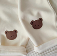 Load image into Gallery viewer, 1 super cozy Top featuring a large Baby Bear face, showcasing your little one's love for bears, and 1 comfy pair of Pants with Bear patches at the knees, adding a playful touch to their outfit.