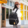 Load image into Gallery viewer, Versatile functionality as a diaper bag, changing table, and travel bassinet.