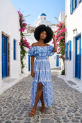 Load image into Gallery viewer, woman wearing blue embroidered off shoulder maxi dress walking by Grecian house spring outfit