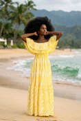 Load image into Gallery viewer, woman wearing yellow floral off shoulder maxi dress on beach summer vacation outfit