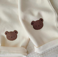 Load image into Gallery viewer, 1 super cozy Top featuring a large Baby Bear face, showcasing your little one's love for bears, and 1 comfy pair of Pants with Bear patches at the knees, adding a playful touch to their outfit.
