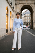 Load image into Gallery viewer, woman wearing blue and white pinstripe wrap blouse tailored fitted elegant top with long sleeves

