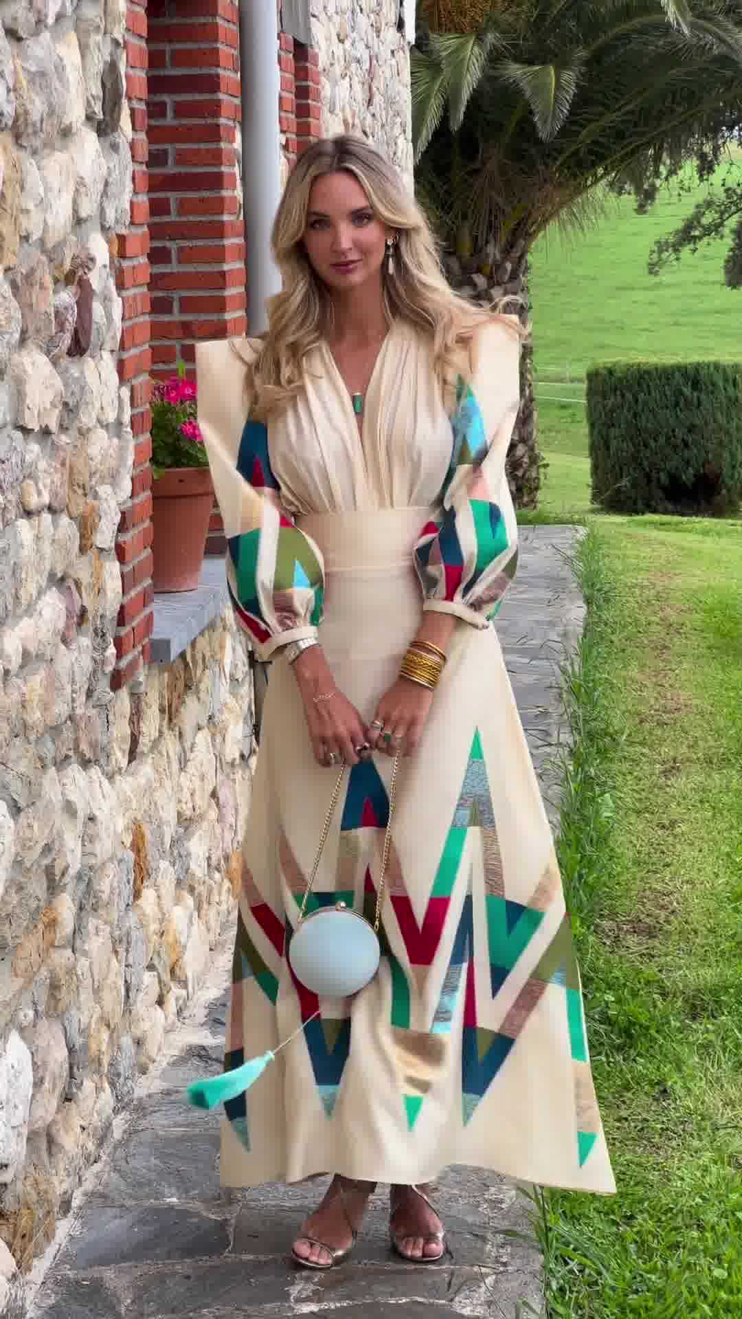 woman wearing geometric print long sleeve midi dress beige colorful pattern elegant spring resort outfit