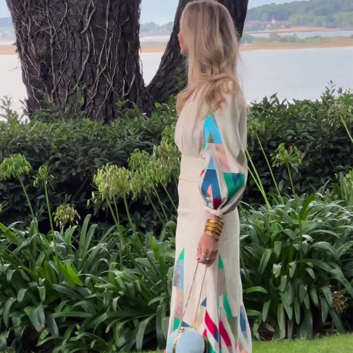 woman wearing geometric print long sleeve midi dress beige colorful pattern elegant spring resort outfit