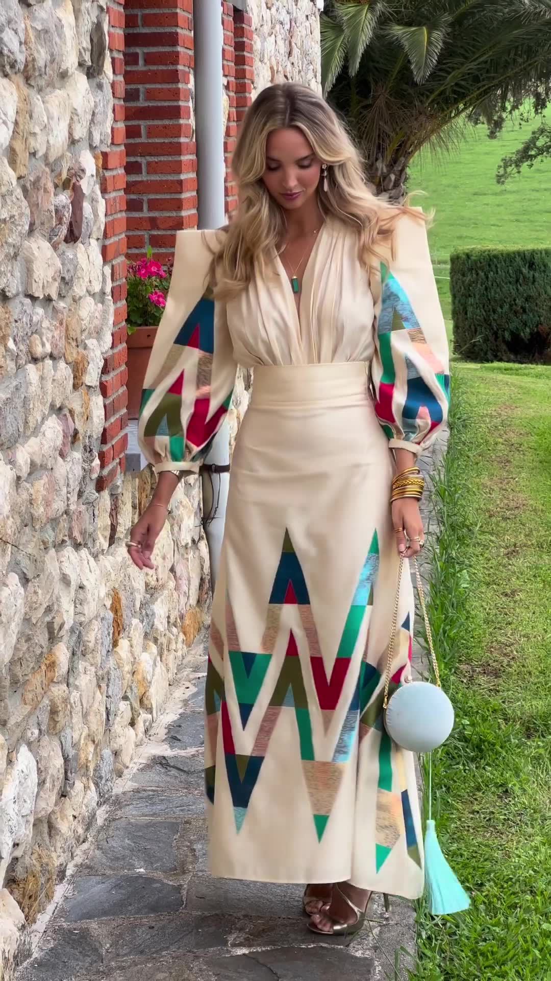 woman wearing geometric print long sleeve midi dress beige colorful pattern elegant spring resort outfit