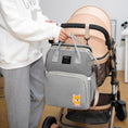 Load image into Gallery viewer, Versatile functionality as a diaper bag, changing table, and travel bassinet
