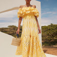 Load image into Gallery viewer, woman wearing yellow floral off shoulder maxi dress on beach summer vacation outfit
