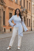 Load and play video in Gallery viewer, woman wearing blue and white pinstripe wrap blouse tailored fitted elegant top with long sleeves
