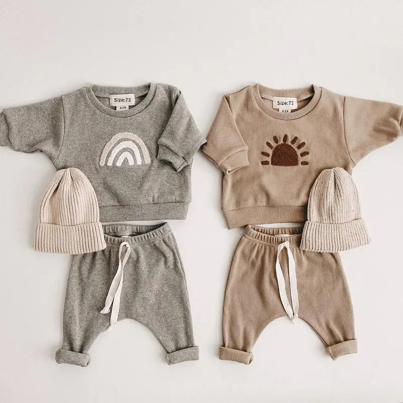 Kyle Unisex Spring Baby 2 Piece Sweatsuit Set. This dynamic duo features an adorable long-sleeved sweatshirt paired with cozy pants, giving your little one an instant dose of charm.